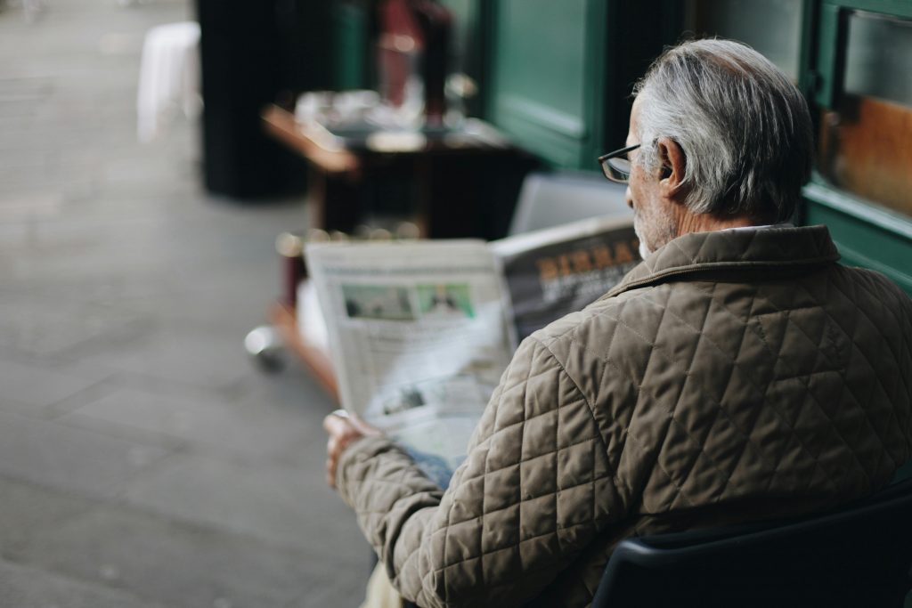 old man reading the news