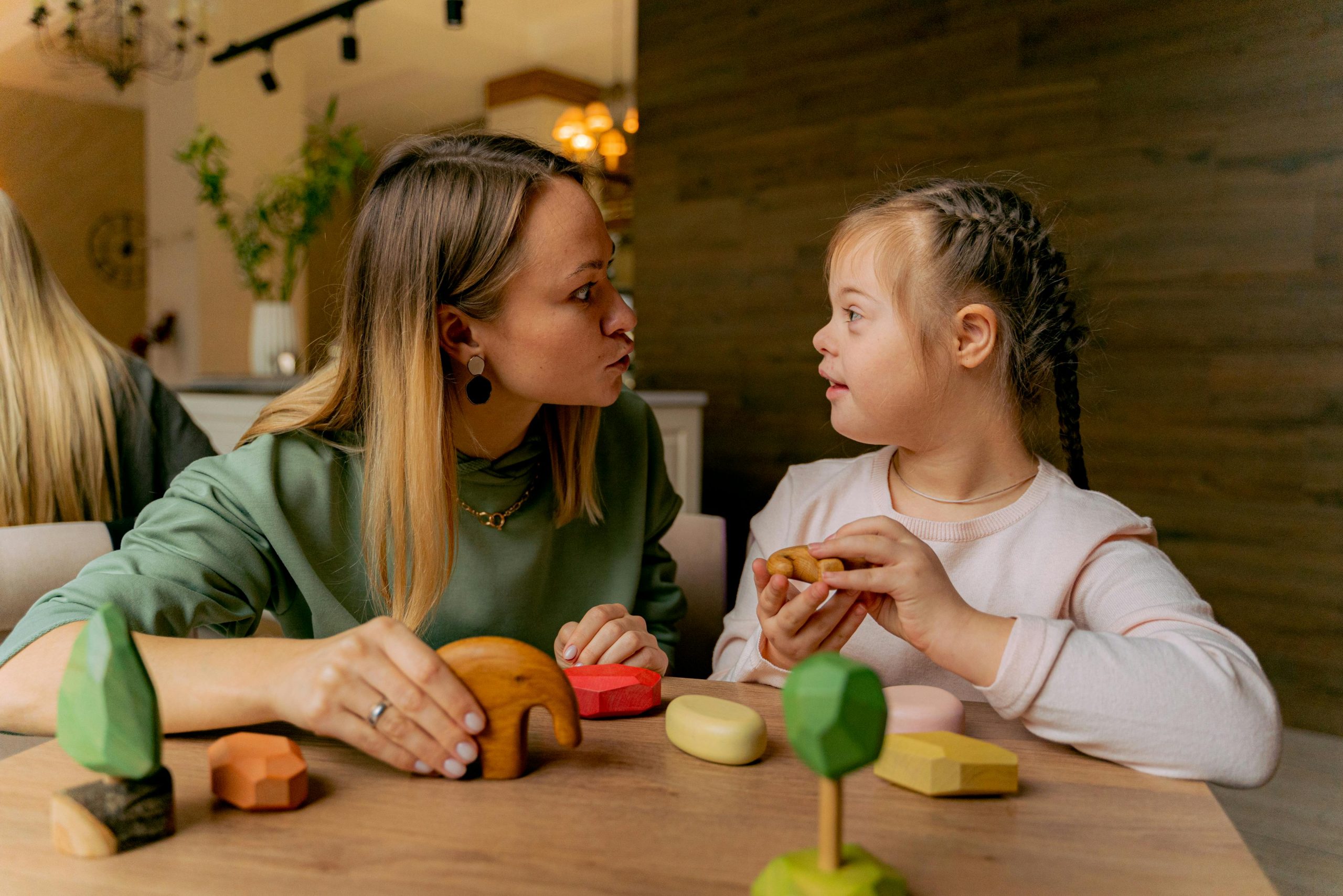 girl with special needs playing with her mother